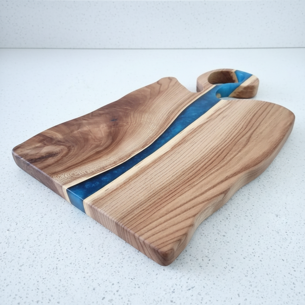 Wooden cutting board with blue resin inlay on a white background